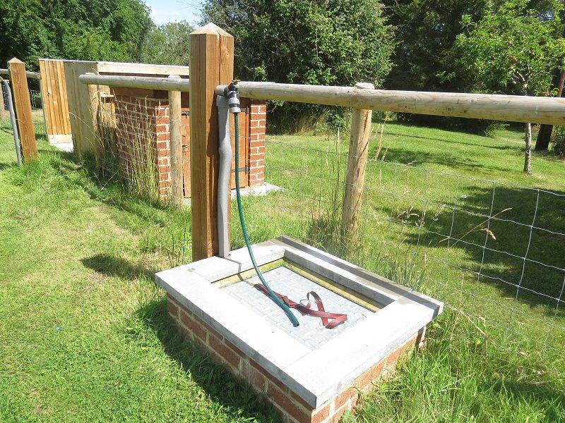 The chemical disposal point, with a fresh water tap on the post beside it.
